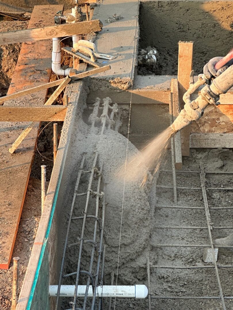 A person pouring cement into the ground.